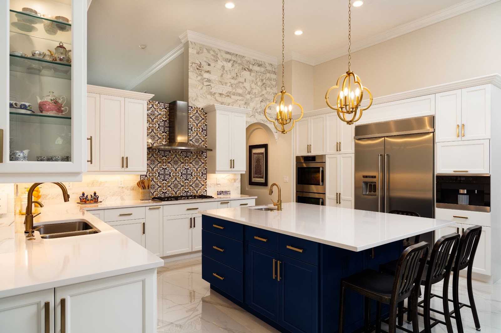 Modern kitchen with navy island and brass pendants