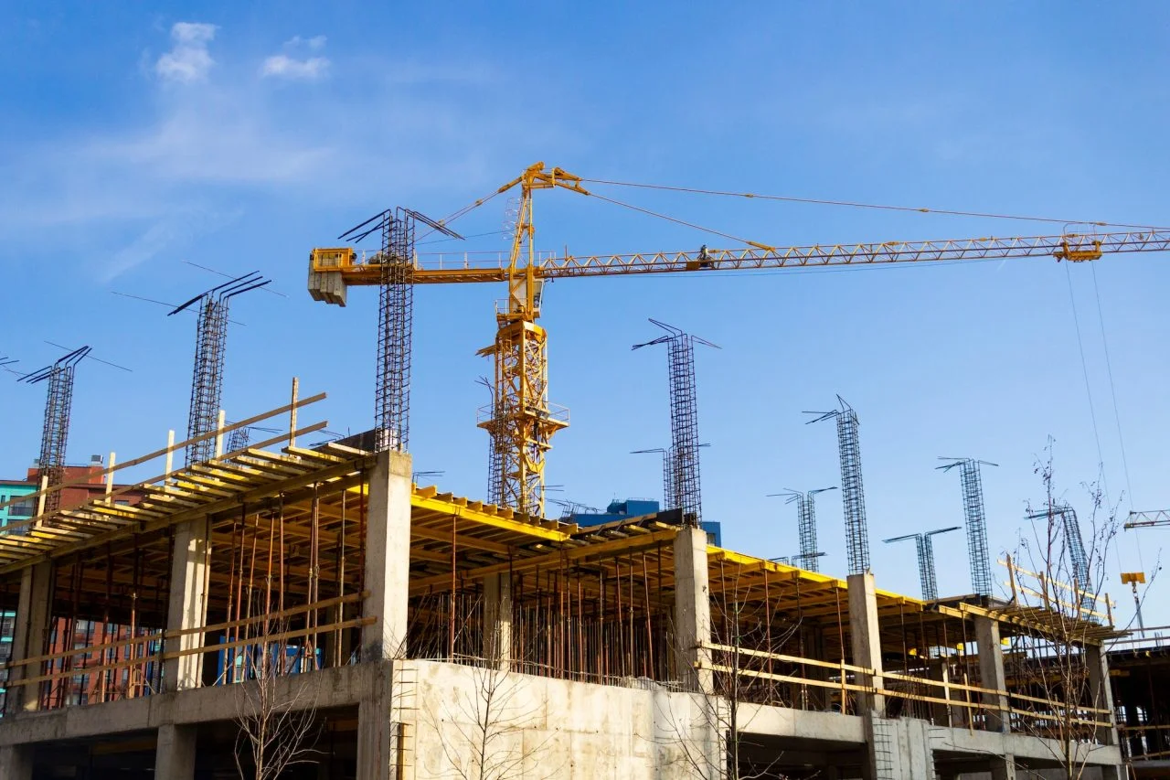 Tower crane above concrete building under construction