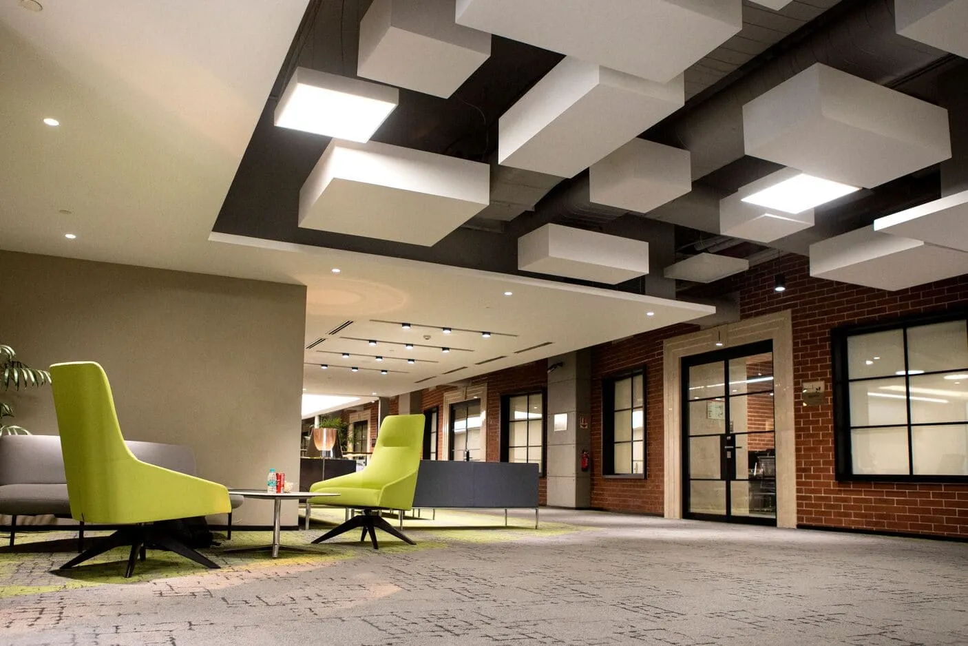 Modern commercial office interior with contemporary seating and acoustic ceiling design